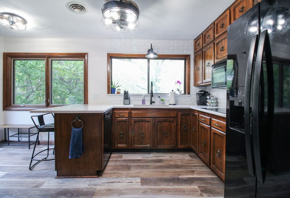 Quartz countertops, new sink, stovetop, refrigerator, oven and dishwasher.