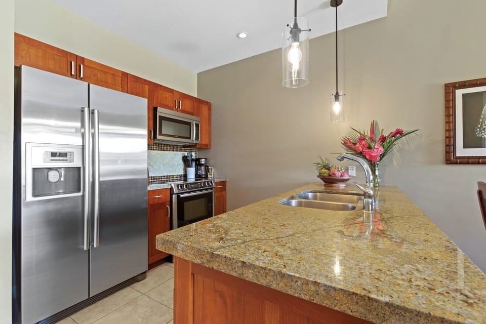 Fully equipped kitchen with granite counters—perfect for tropical culinary creations.
