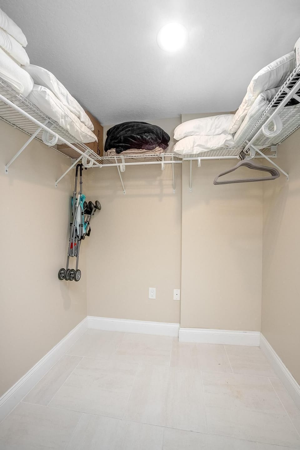 Primary Closet with extra blankets, pillows and single child's foam mattress