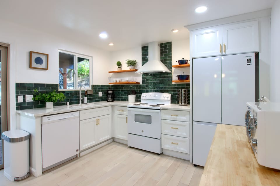 Bright, inviting kitchen with white appliances and sleek countertops.