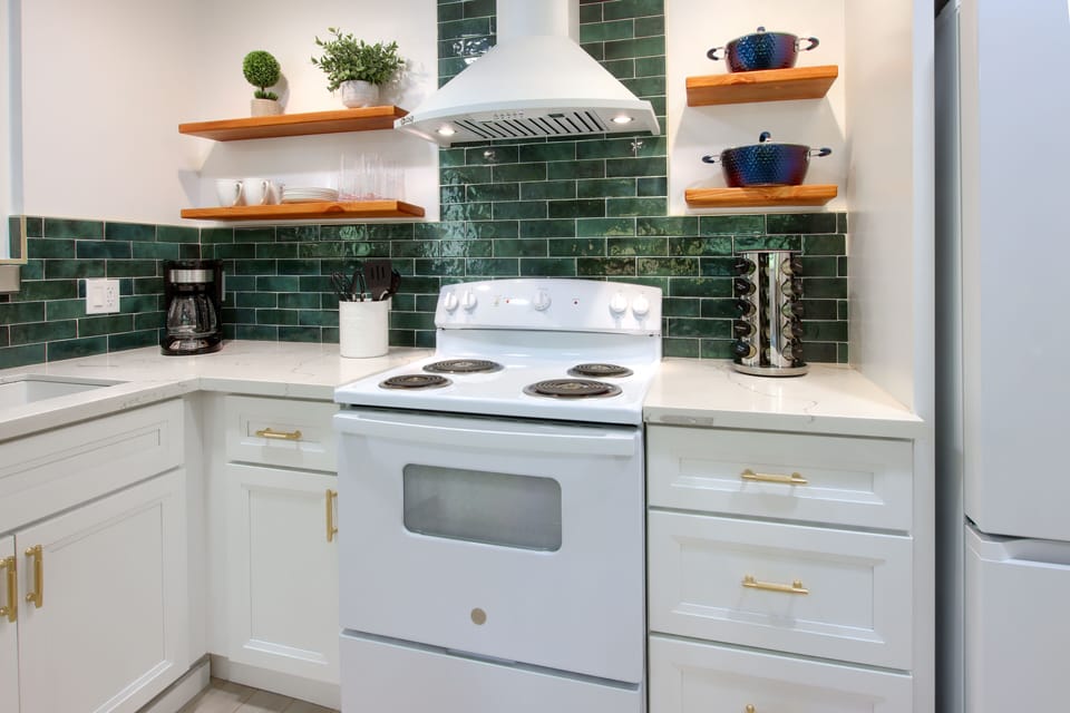 White full kitchen featuring a four-burner stove for versatile cooking.
