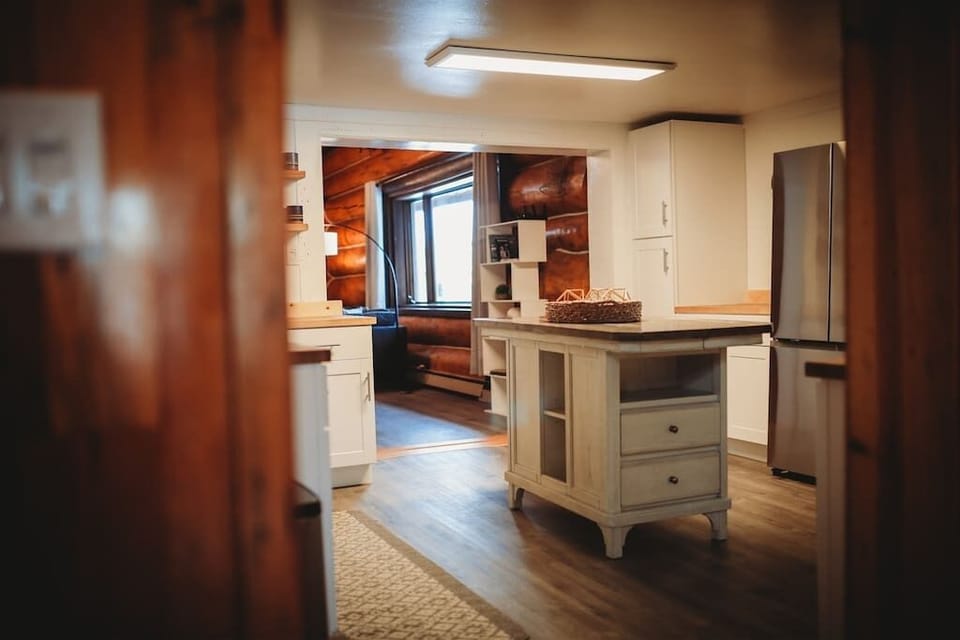 Newly remodeled kitchen with modern finishes, a central island, and a seamless connection to the cozy living space.