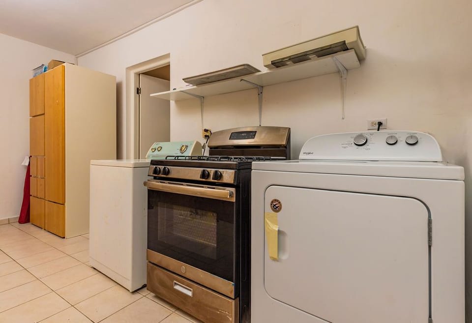 A kitchen with stove and oven