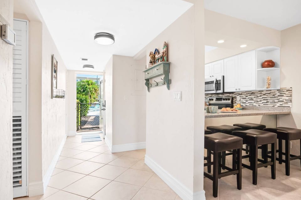 The beach access is just across the street and the pool access is literally right outside the front door. First floor living is grand!