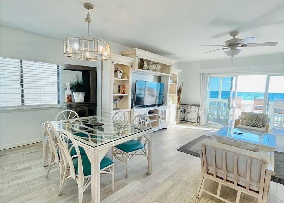 Step into your bright oceanfront dining space where meals become memorable with stunning sea views through floor-to-ceiling windows.