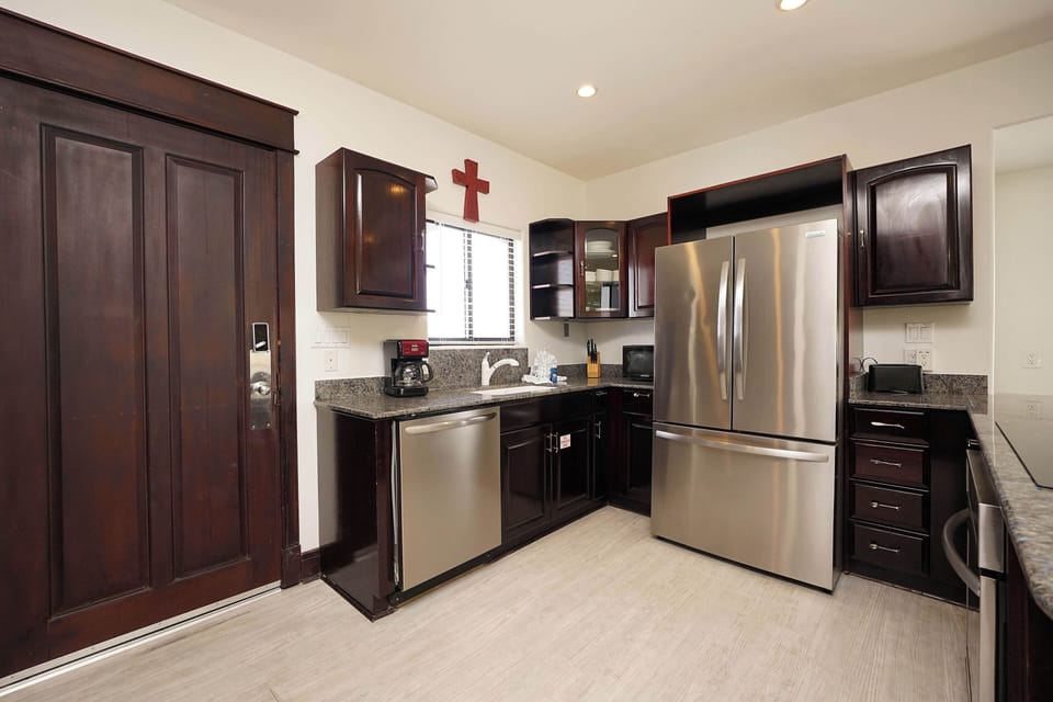 Your fully equipped kitchen features stainless steel appliances, granite countertops, and rich cherry cabinets for all your culinary needs.