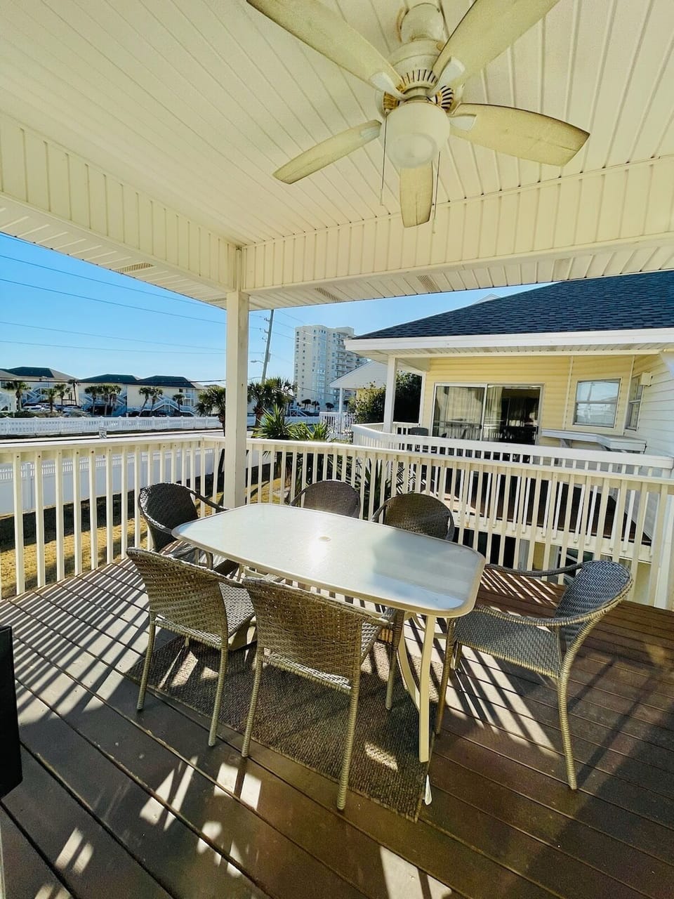 Relax on your private deck with ocean breezes from the ceiling fan, dining table for six, and coastal views stretching beyond.
