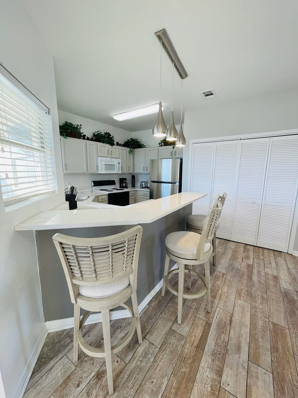 Your fully equipped kitchen features modern appliances and a cozy breakfast bar where you can enjoy morning coffee.