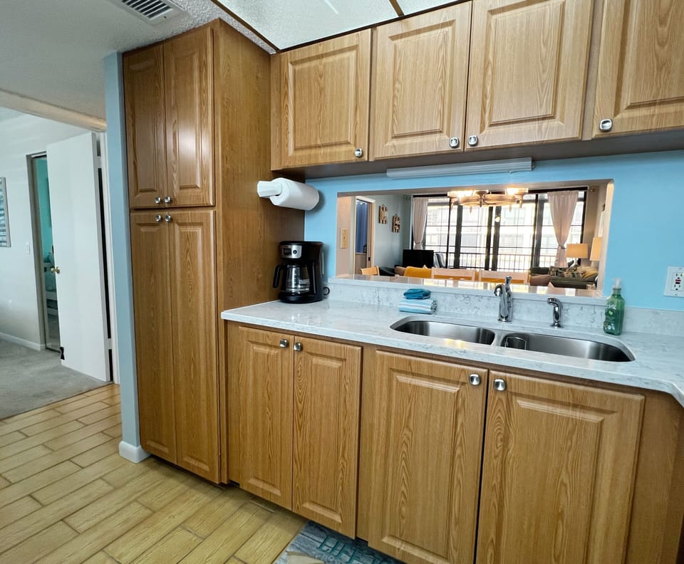 View of the kitchen facing the living room and guest bedroom. - View of the kitchen facing the living room and guest bedroom.