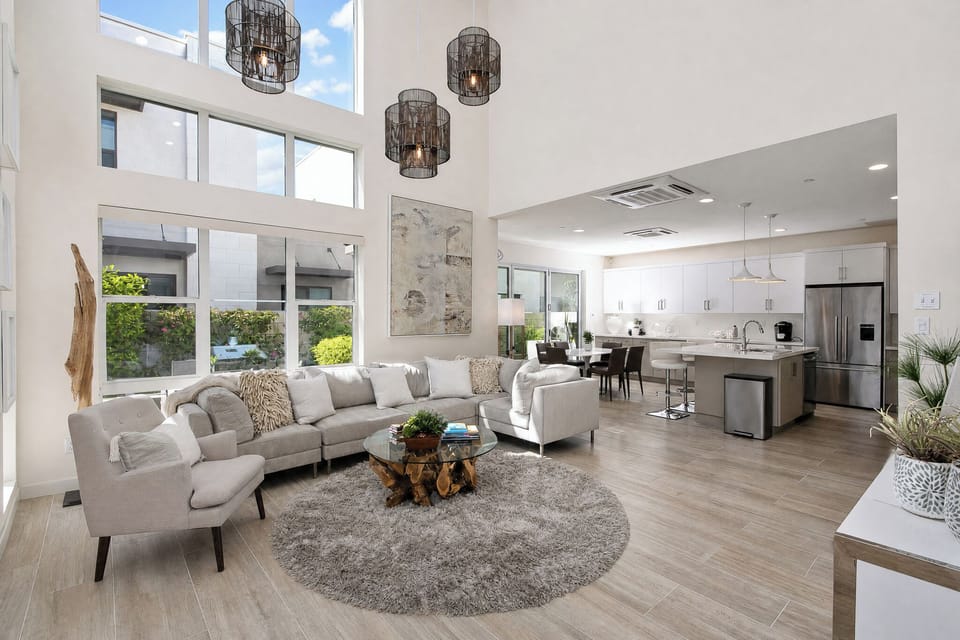 Relax in this airy open-concept space with soaring ceilings, sunlit windows, and a seamless flow from the living room to the modern kitchen, perfect for unwinding or entertaining.