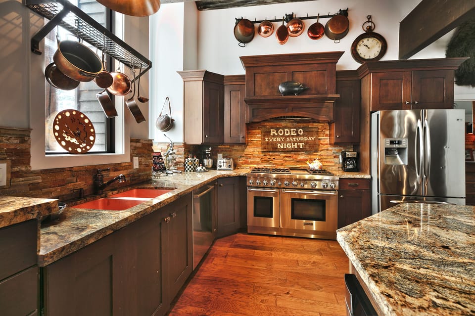 Granite countertops and stainless steel appliances in