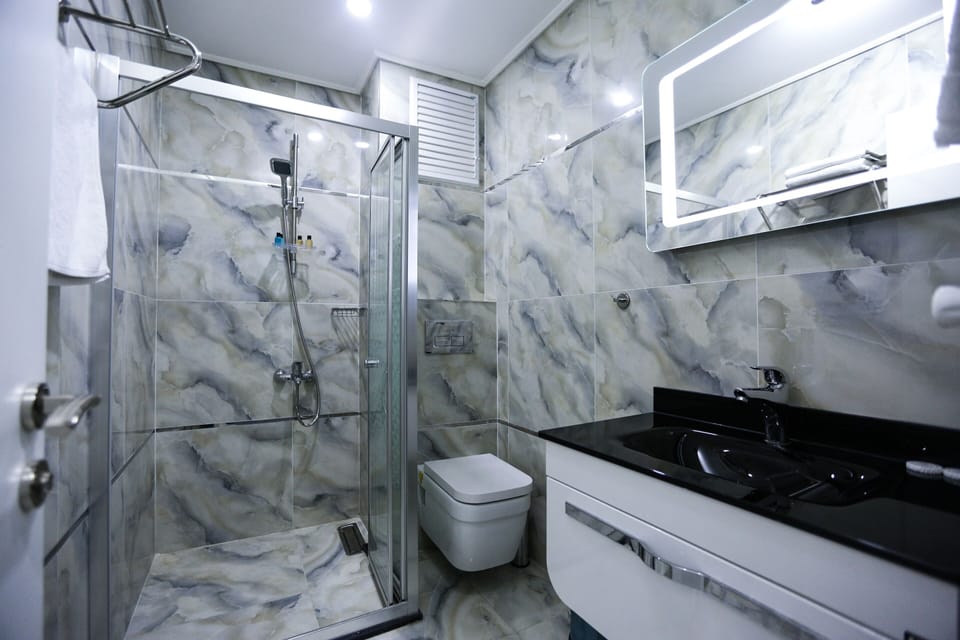 Shower, hair dryer, slippers, towels