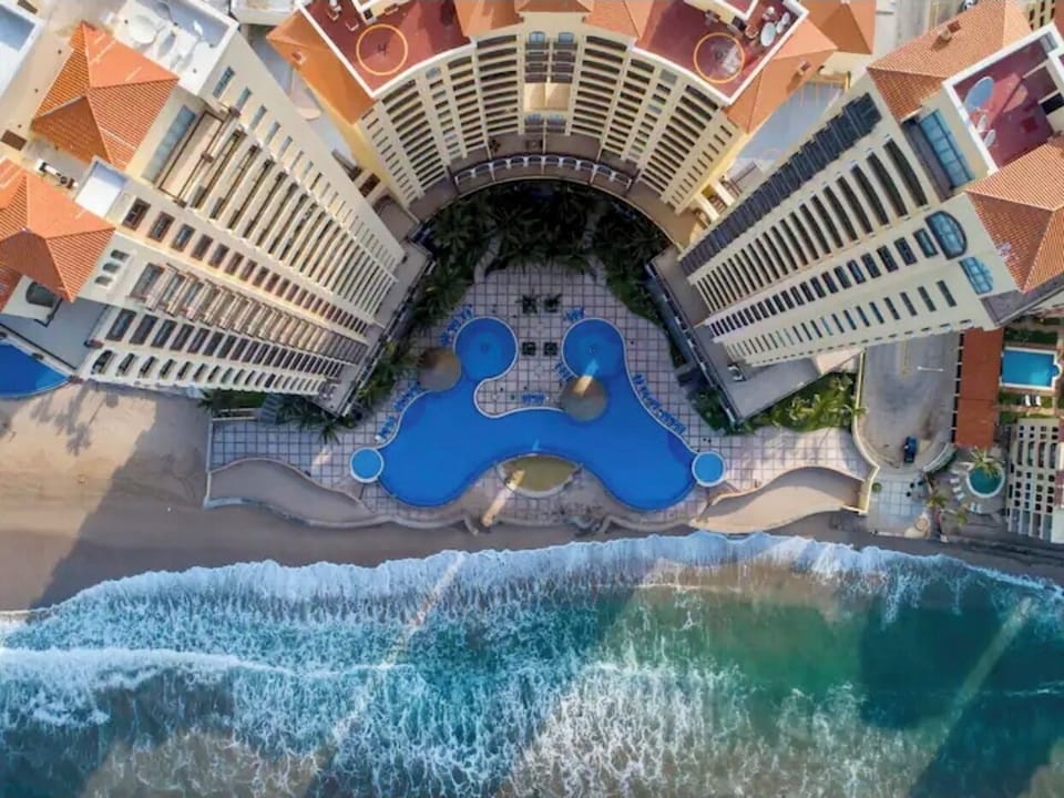 The condo is on the south tower, 9th floor (right bldg on this beach side view).