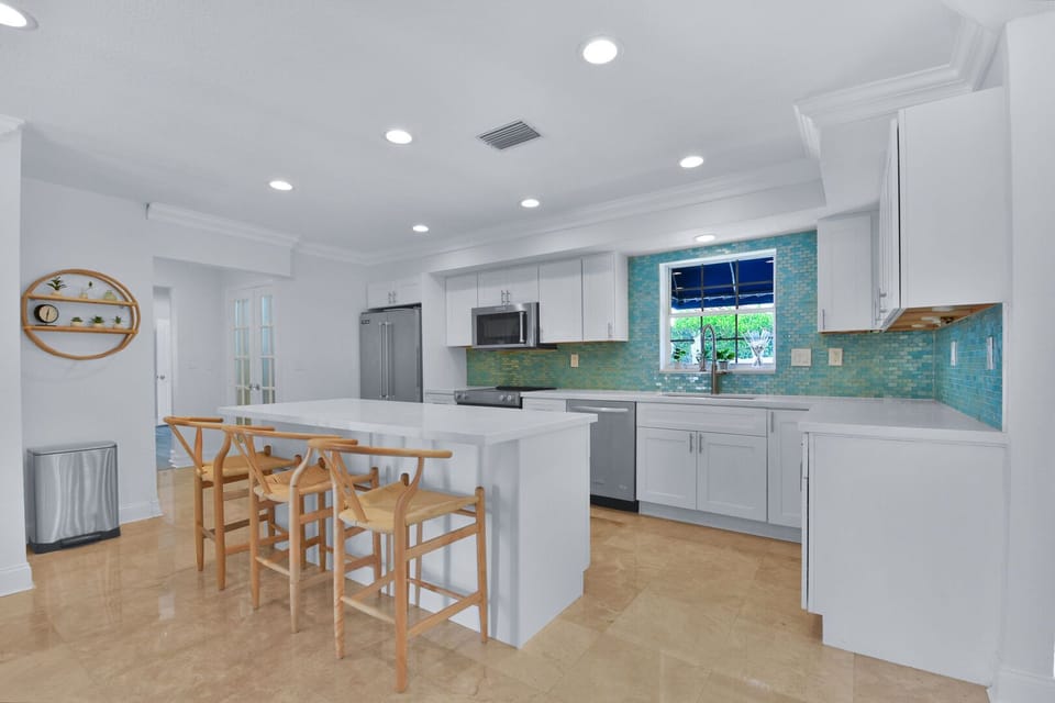 Open plan kitchen with modern fittings and utensils provided.