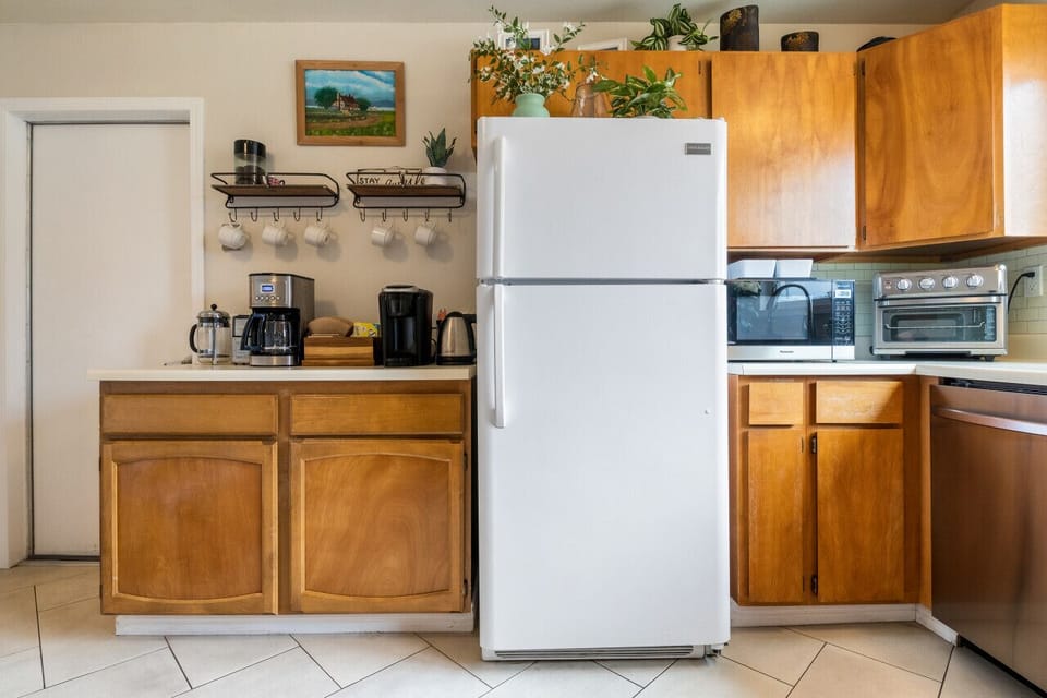 Fully equipped kitchen with coffee station and air fryer.