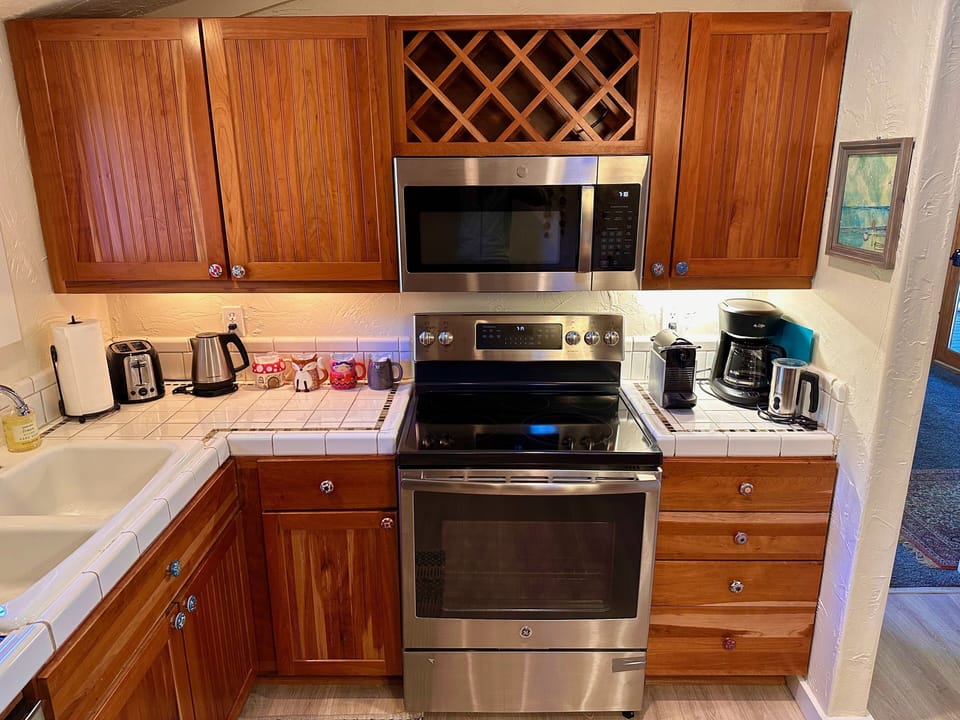 Kitchen with microwave, toaster, kettle, Nespresso coffee & drip coffee machines