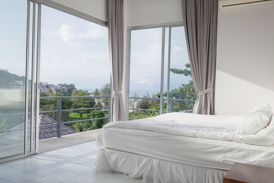 Bedroom with sliding glass doors and great ocean views, with attached bathroom. 
