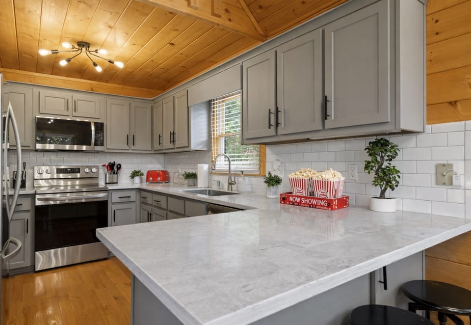 Step into the cream-toned kitchen... fully stocked, beautifully designed, and ready for feasts.