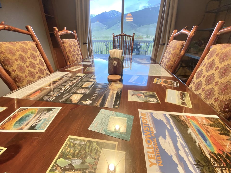 Custom dining room table with Yellowstone & Montana maps & memorabilia.