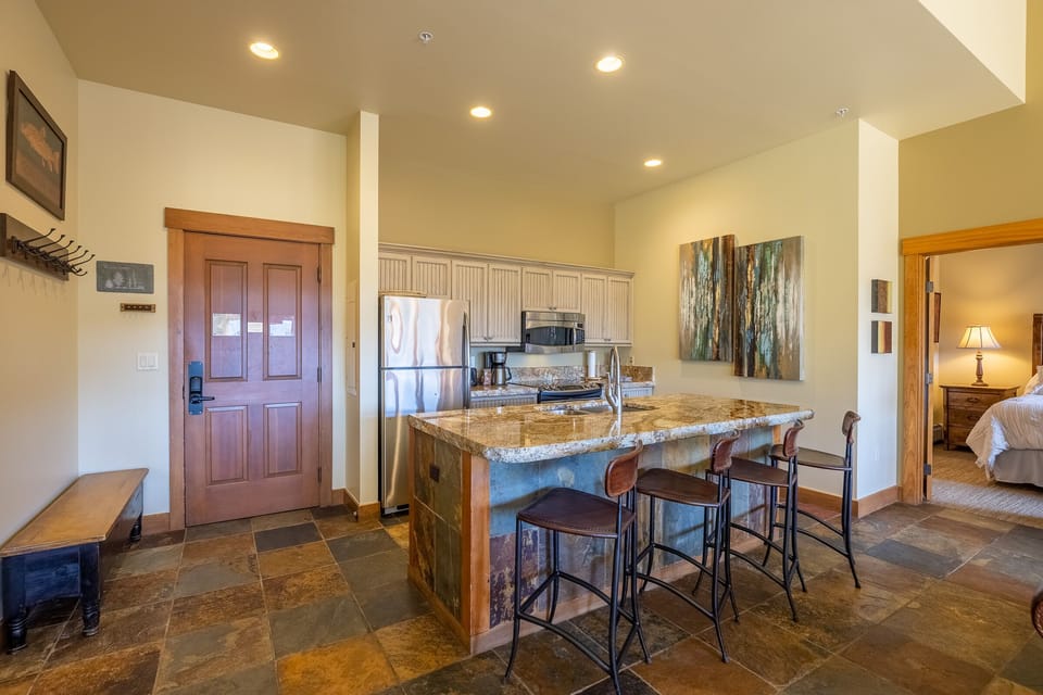 Kitchen and entry, doorway to king master suite in right of photo