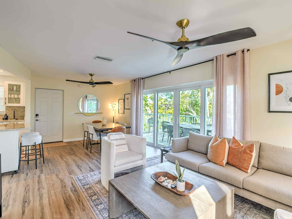 Living and Dining Spaces with Large, 4-Panel Patio Door to Deck