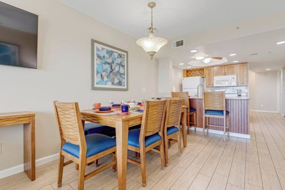 Large dining table with extra seating at the breakfast bar.
