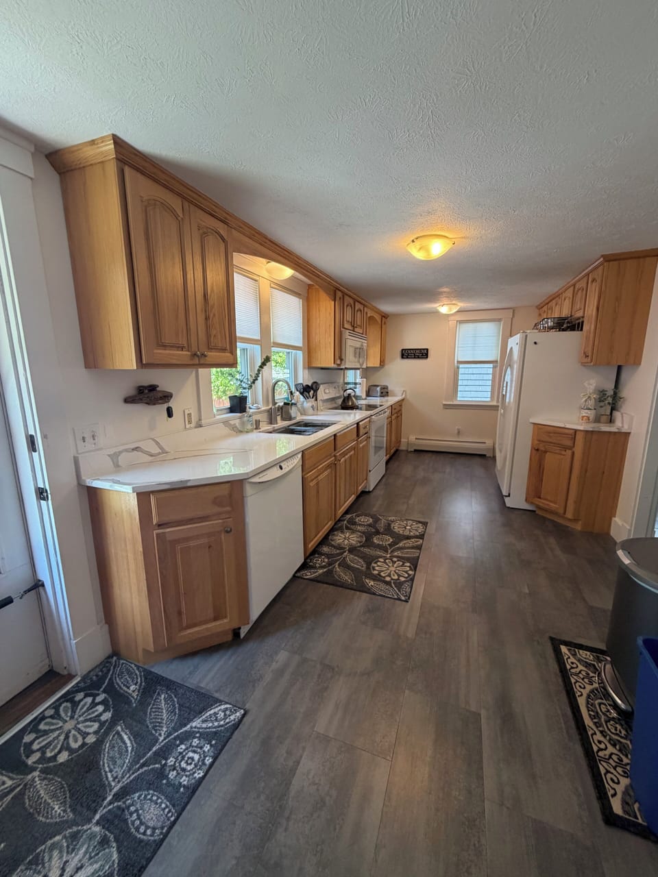 Large, long, galley kitchen with lots of counter space for dinner prep.