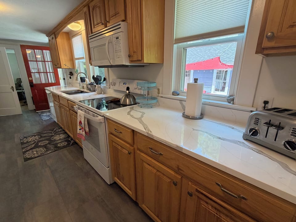 Kitchen overlooks the back patio and is where people enter the house. 