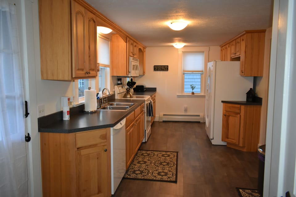 Large, long, galley kitchen with lots of counter space for dinner prep.