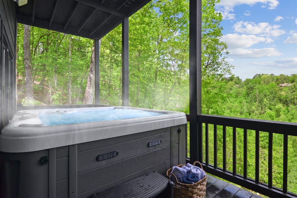 Slip into the bubbling hot tub on the covered deck, rolled towels within reach, and soak in the green forest view without ever leaving your railing.