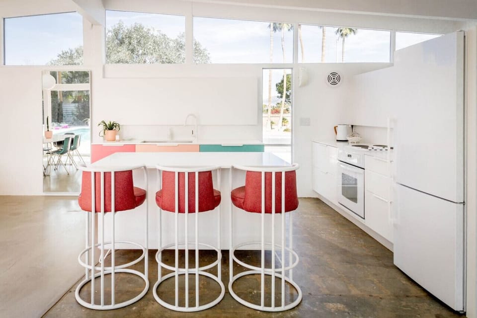 Bright, modern kitchen with retro flair 🍒✨ Cook, sip, and gather around the colorful island in this sunlit Palm Springs retreat. Perfect for entertaining! #DesignLovers #PalmSpringsStyle