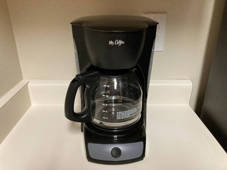 The Caffee maker and Keurig machine are in the kitchen with some essentials.