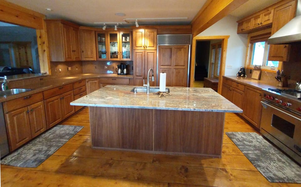 The huge kitchen boasts Wolf and Dacor ranges with a Subzero refrigerator