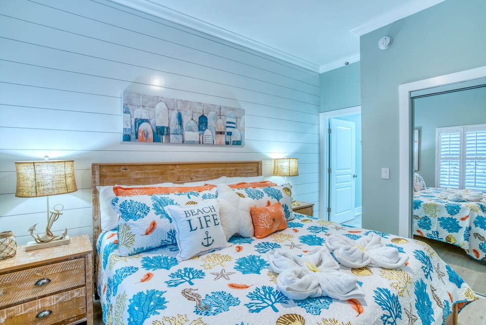 Spacious king master suite with coastal decor and private connected bath 