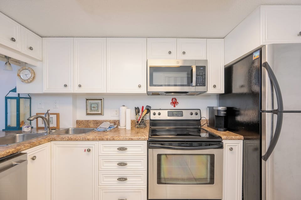 Craft delicious meals and enjoy quality family time as you gather in this inviting kitchen filled with coastal charm