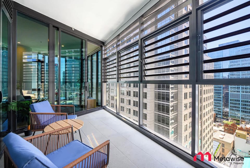 Balcony with outdoor seating and city views.