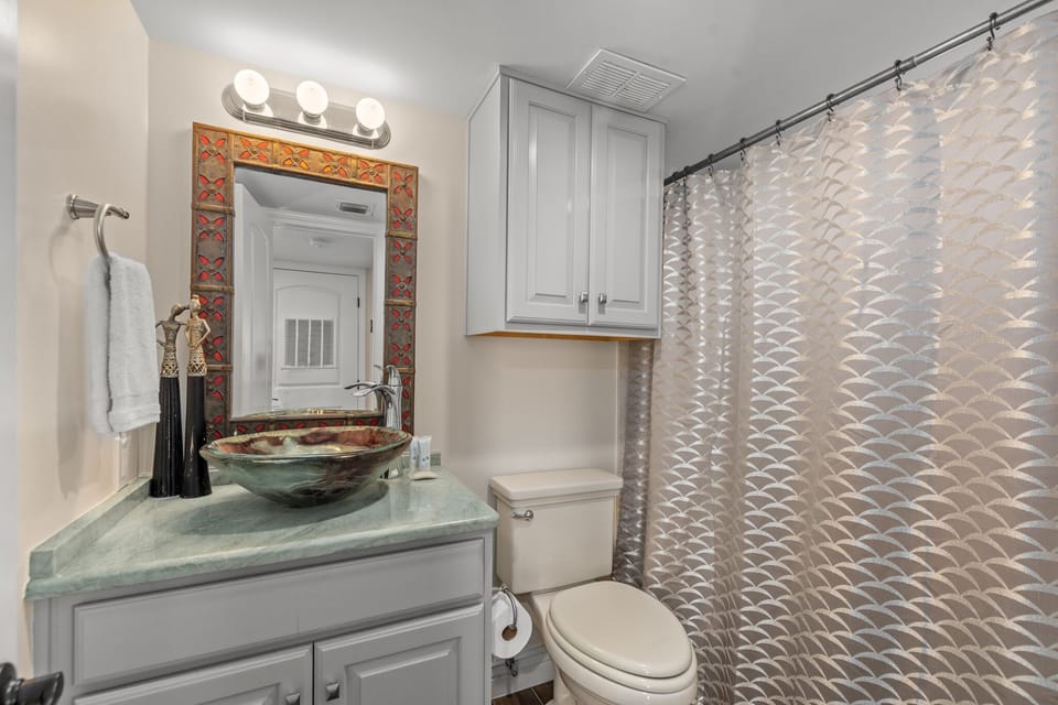Custom decorative glass sinks in each bathroom. Zoom in to this one. L’Occitane!