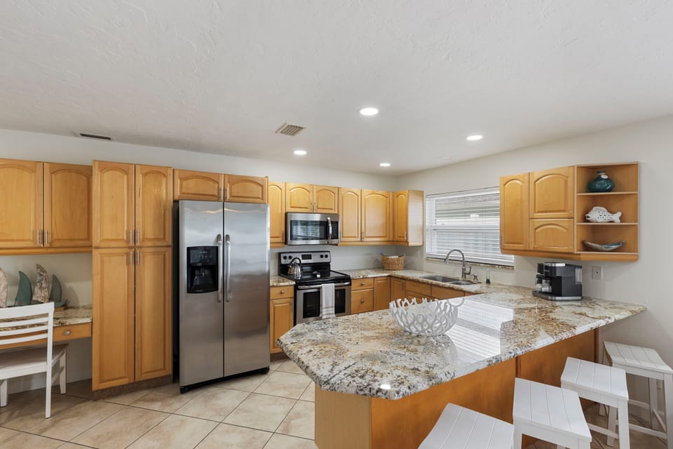 Cook with ease in this generous kitchen featuring stainless steel appliances and ample counter space