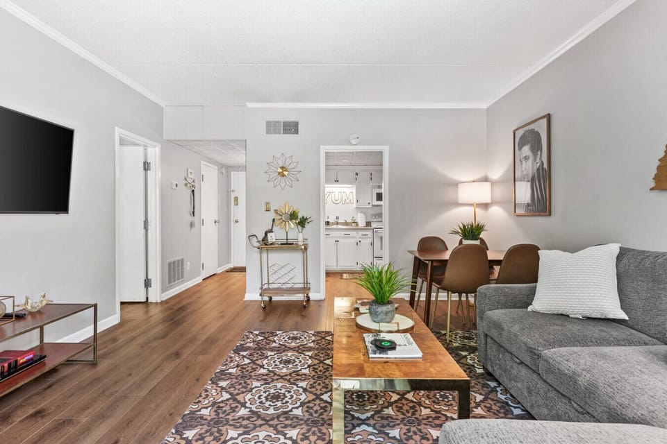 Bright and spacious living room off the kitchen. Smart TV, room darkening shades, and pull-out sleeper sofa for ultimate comfort + Dining table that can seat 4 people!