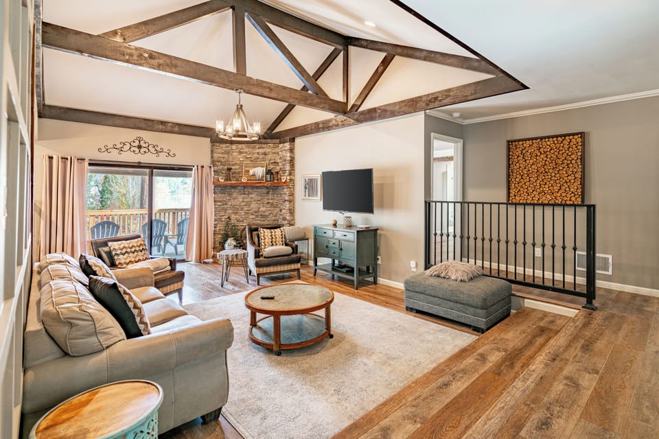 Bright living area with TV and deck access.