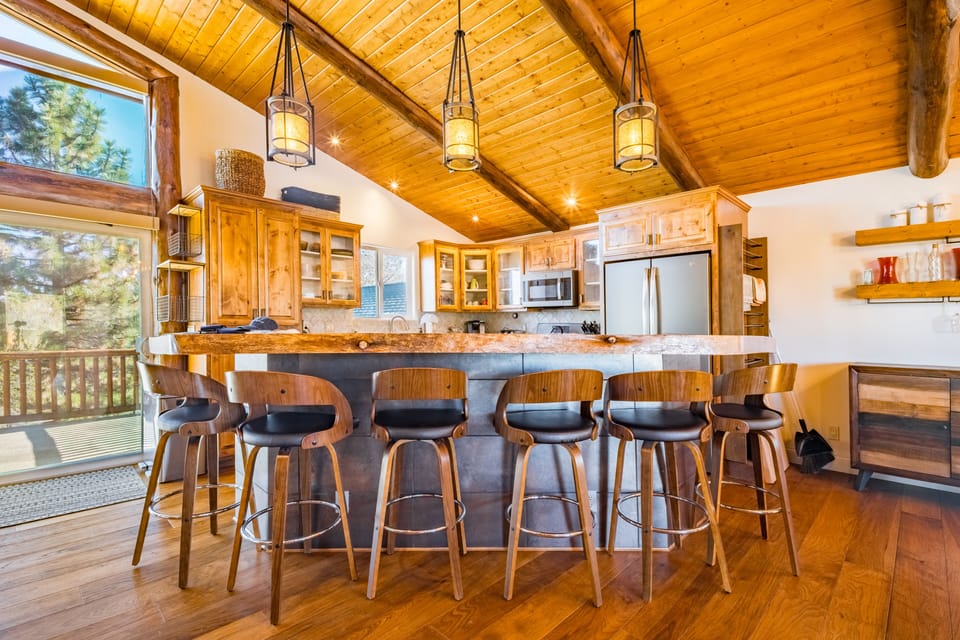 Fully equipped chef's kitchen with plenty of barstool seating.