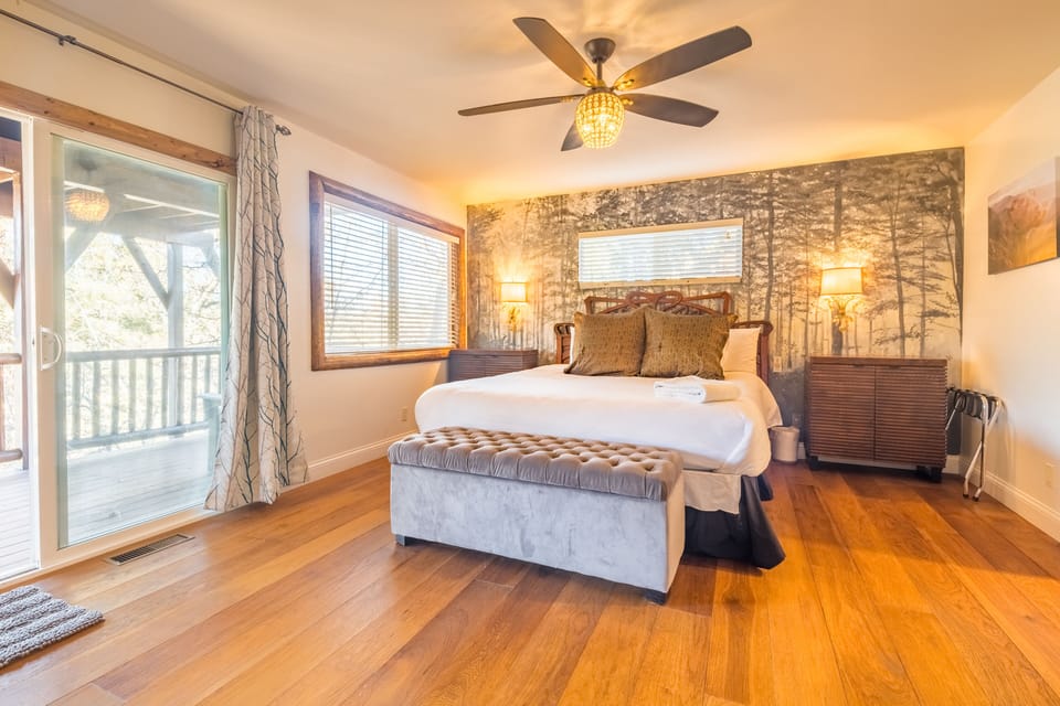 Primary bedroom features a king bed, balcony, TV, and ensuite bathroom.