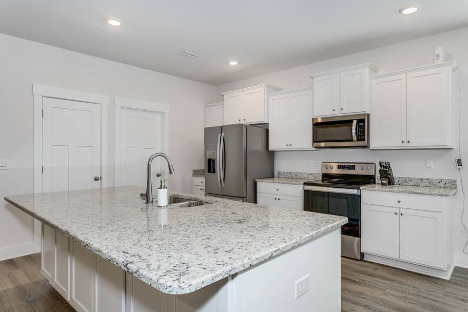 Brand new kitchen with new stainless steel appliances and beautiful granite counter tops