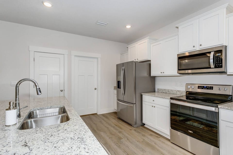 Bright and spacious kitchen that's ready for some baking fun! Lots of cabinets for storage!