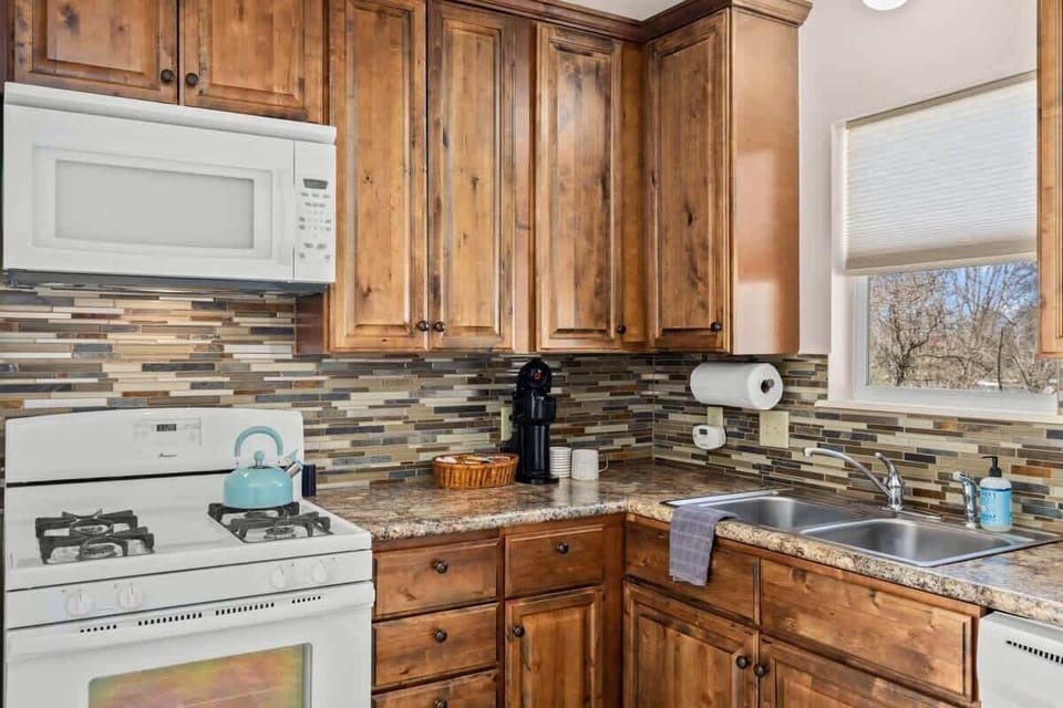 Fully equipped kitchen with gas range, dishwasher, and Keurig, cook your favorite meals with ease.