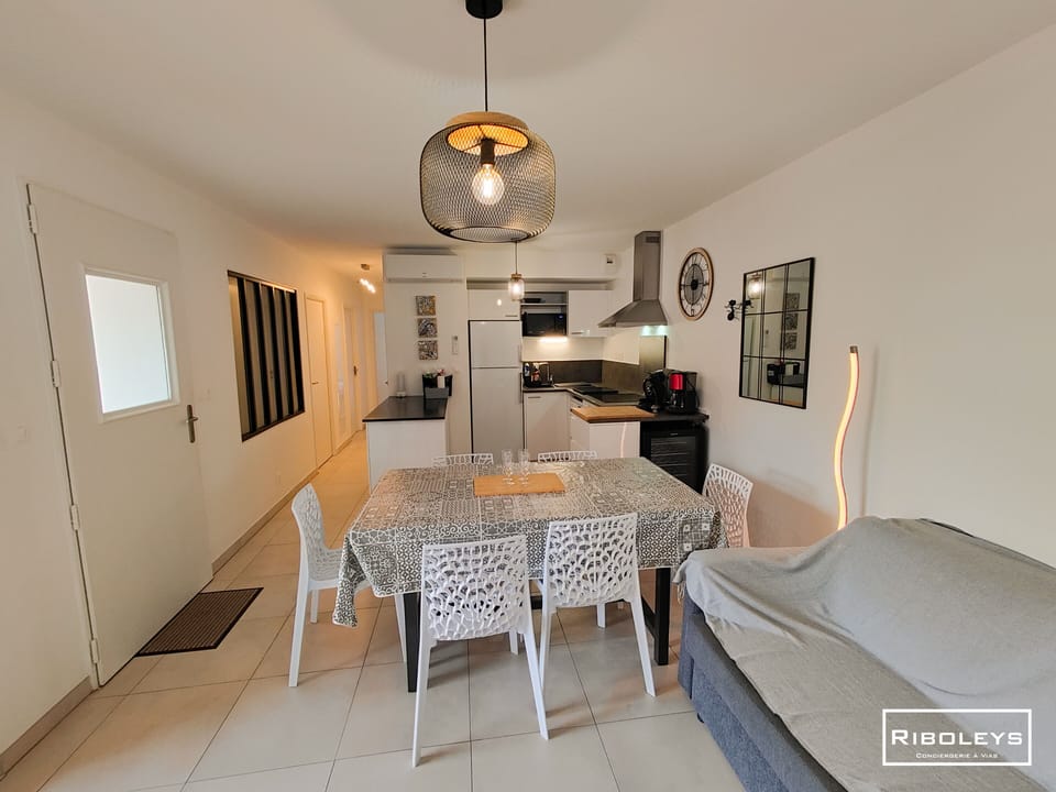 Kitchen opening onto living room with television