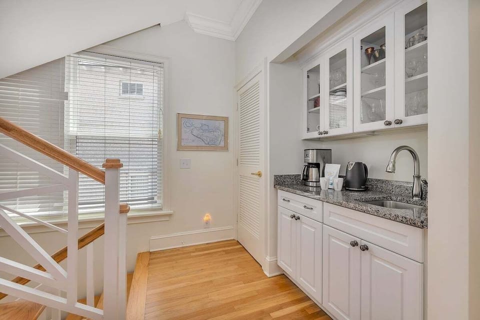 Second landing kitchenette with coffee maker, sink, and cabinets