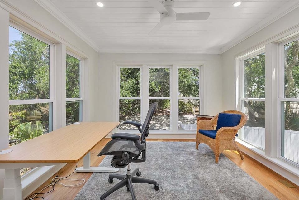 Bright home office with large windows and garden views