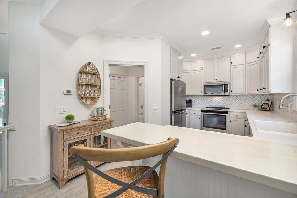 Alternate view of kitchen area and island seating