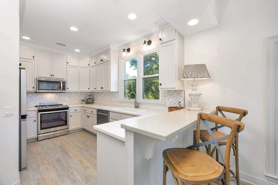 Bright kitchen with stainless steel appliances and island seating